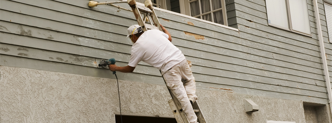 man repairing damaged siding